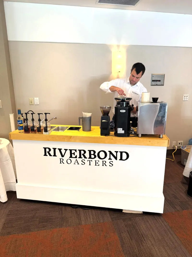 The Riverbond Roasters coffee cart set up at an indoor event